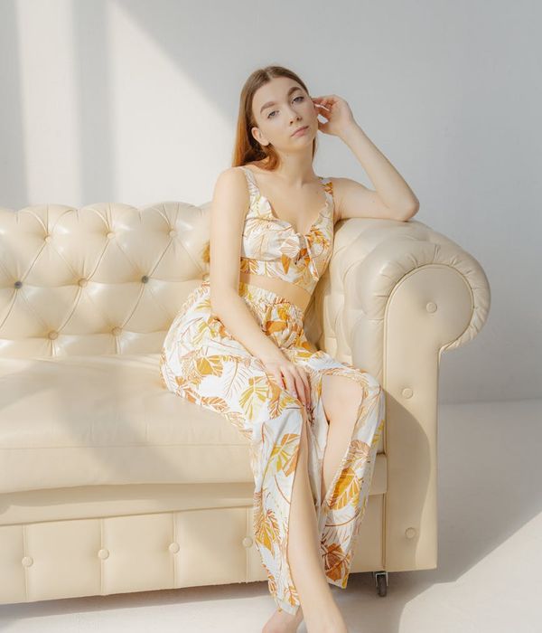 Woman meditating peacefully in a bright, sunlit room.